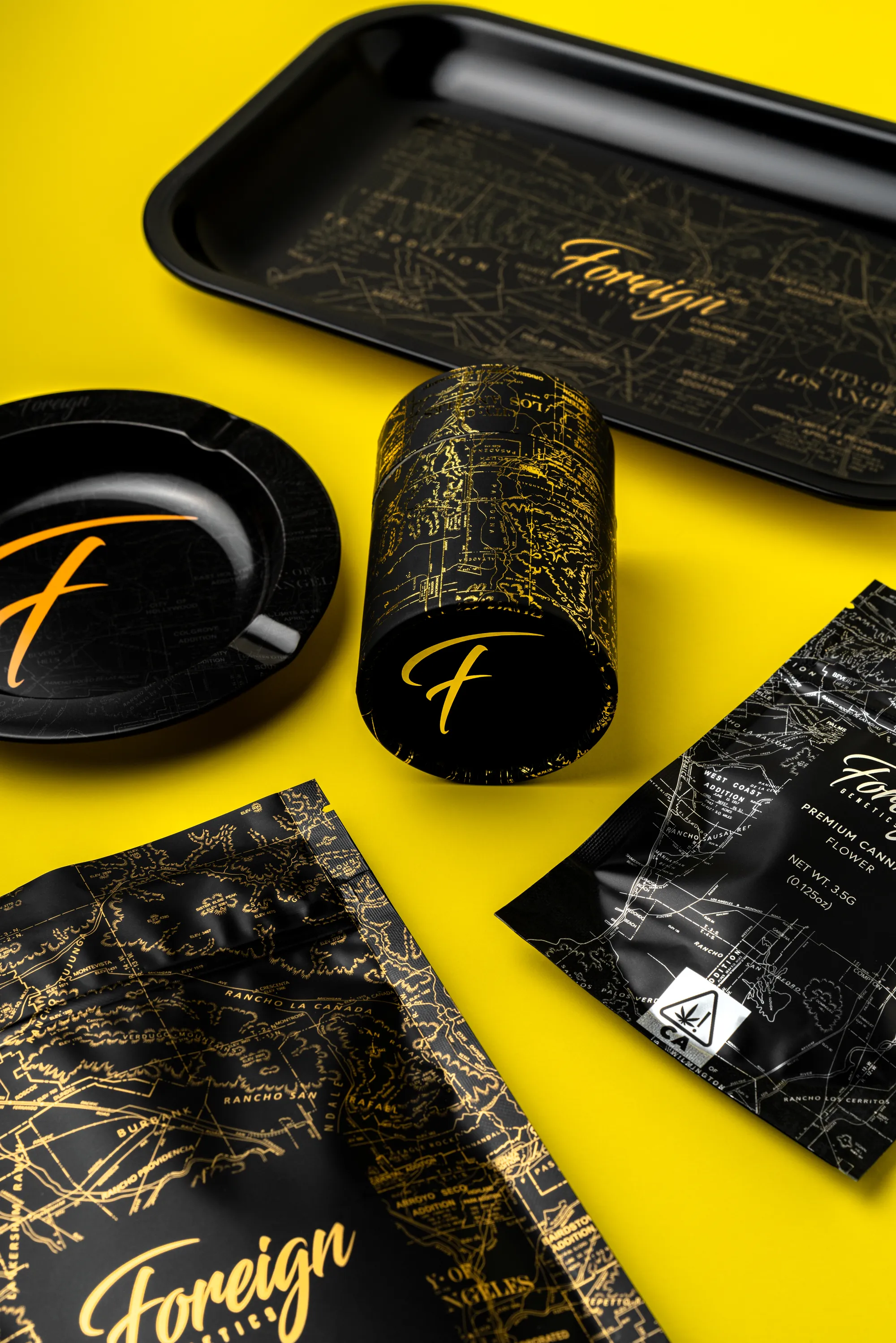 Rolling tray, ashtray, tube and bags on yellow